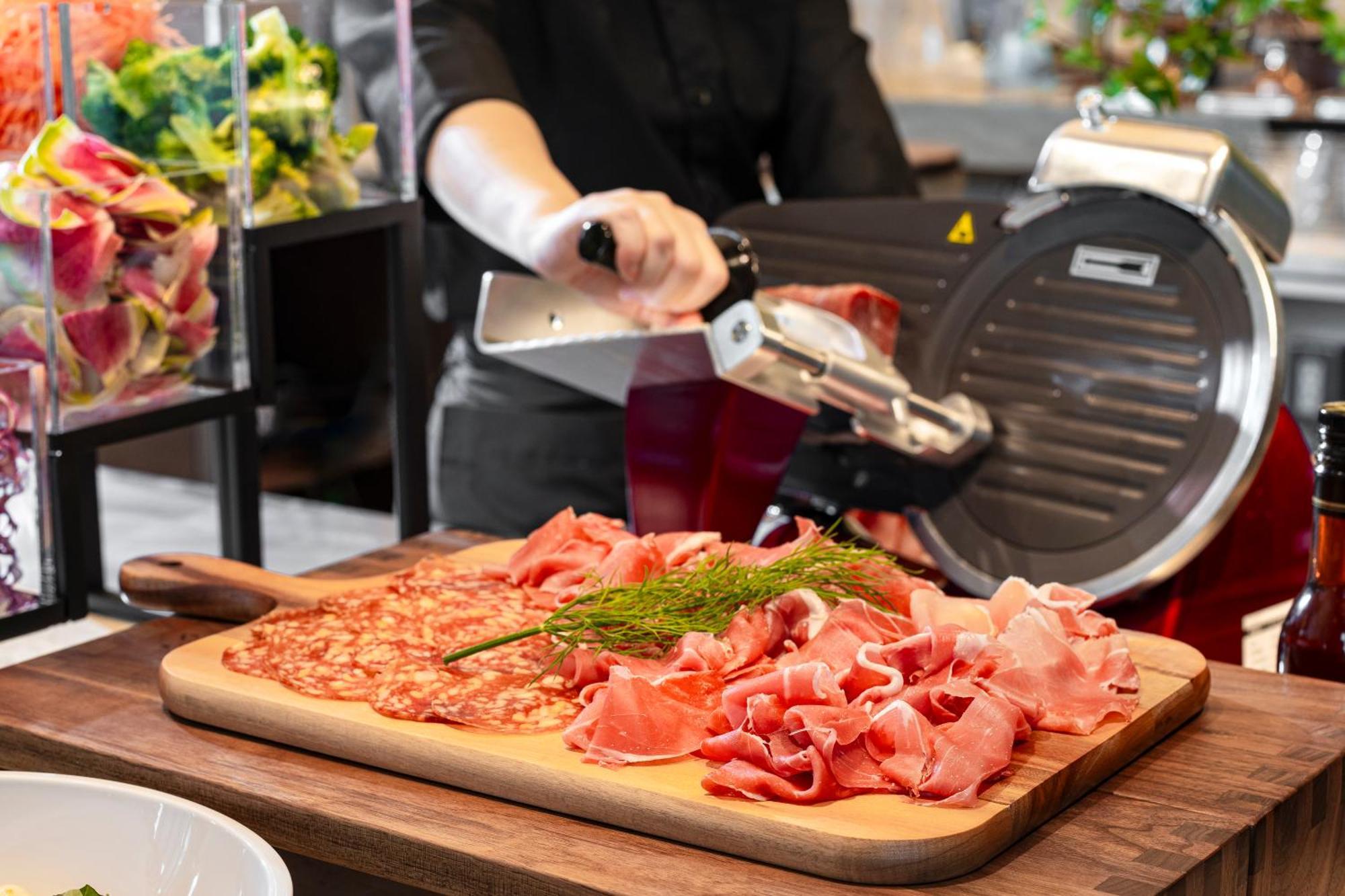 Candeo Hotels Osaka The Tower 외부 사진 A deli slicer in action